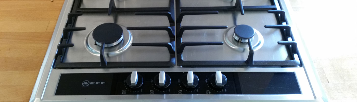 A freshly cleaned stainless steel gas hob and oven